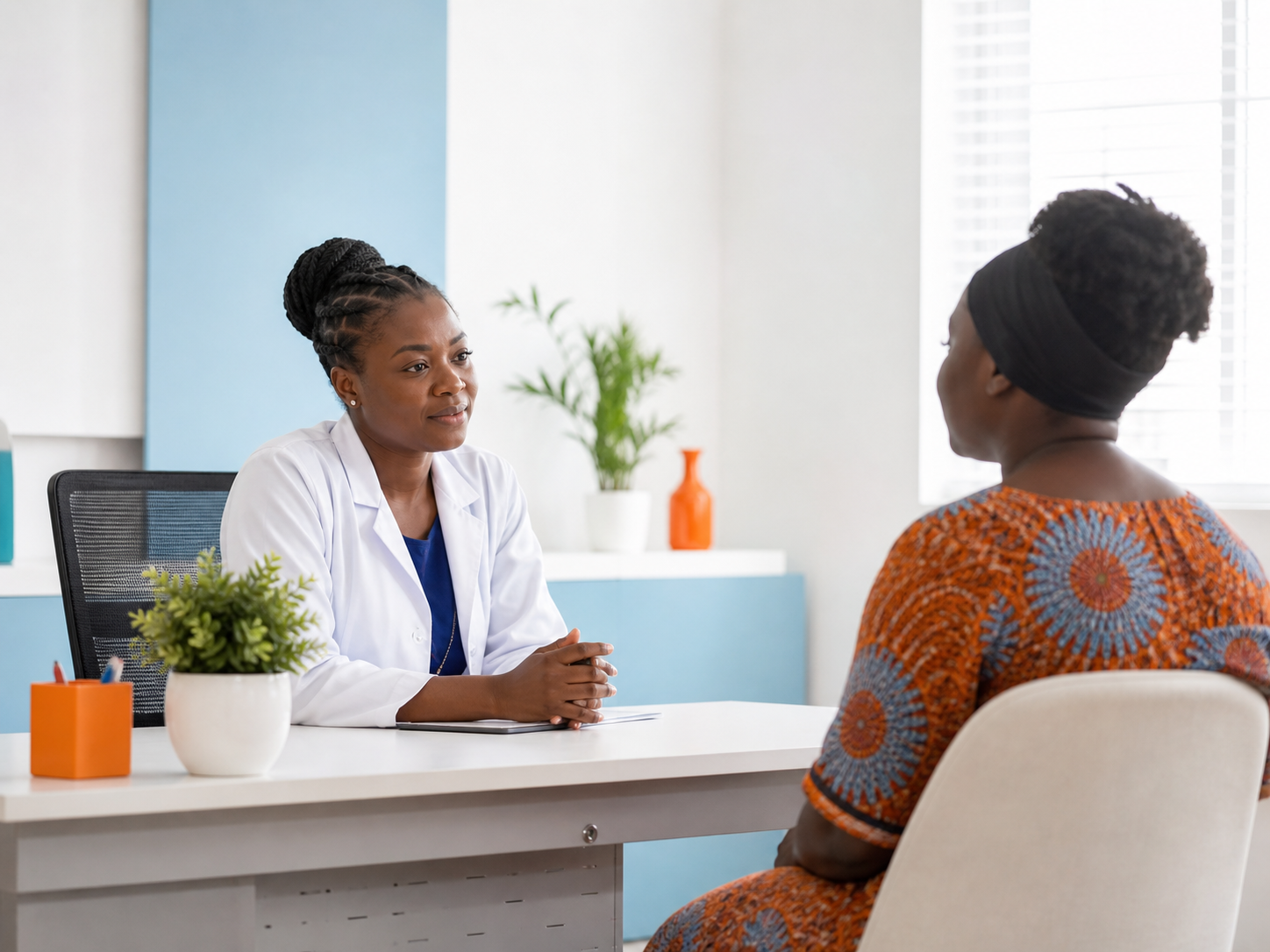 Doctor speaking with a patient in a bright clinic consultation room